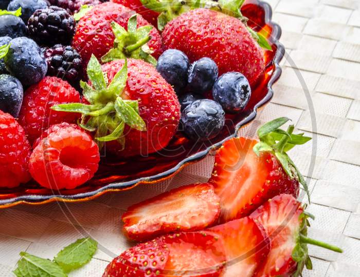 A plate of fresh summer fruit with strawberries