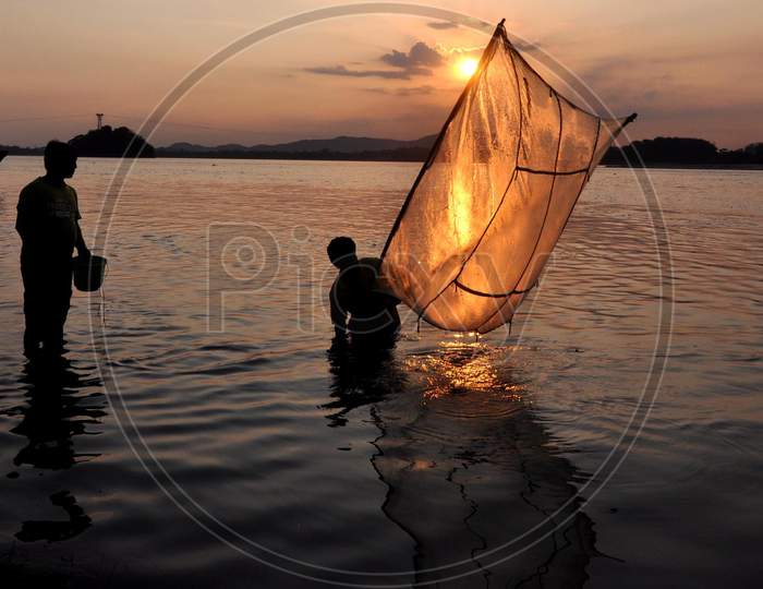 A Man Catches Fish At The Banks Of The Brahmaputra River During Sunset  In Guwahati, Saturday, May 9, 2020.