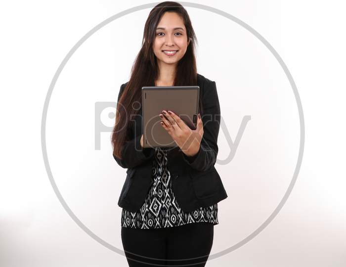 An Attractive Young Executive Assistant Stands Ready To Take Notes On Her Digital Device.