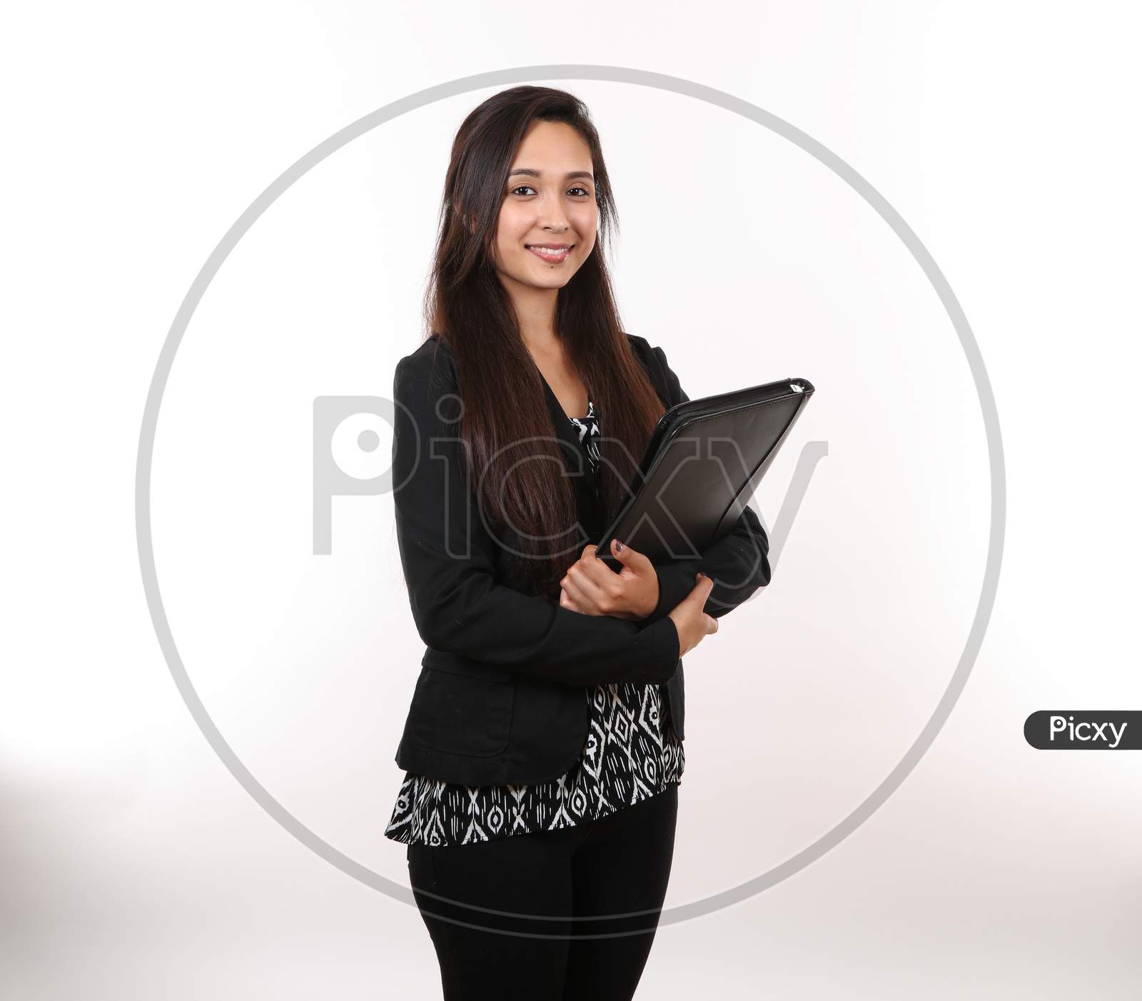 A Young Hispanic Business Woman Holds Her Portfolio.