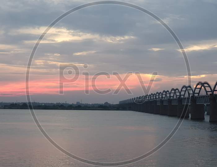 Scenic view of Railway bridges across the Godavari river at sunset
