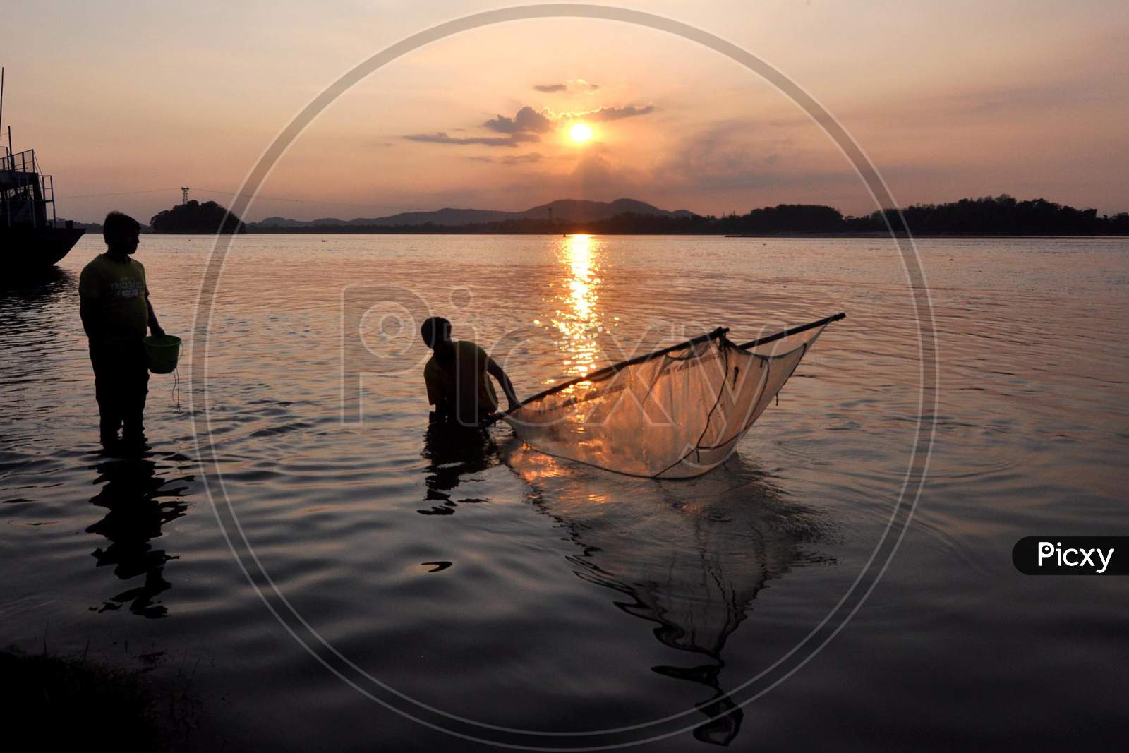 Man Catches Fish At The Banks Of The Brahmaputra River During Sunset  In Guwahati, Saturday, May 9, 2020.