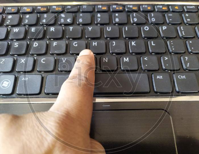 a hand is  business working  typing on laptop keyboard
