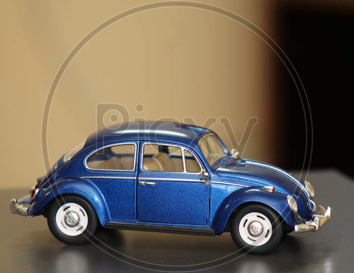 A Miniature Car Isolated On A Blurred Background