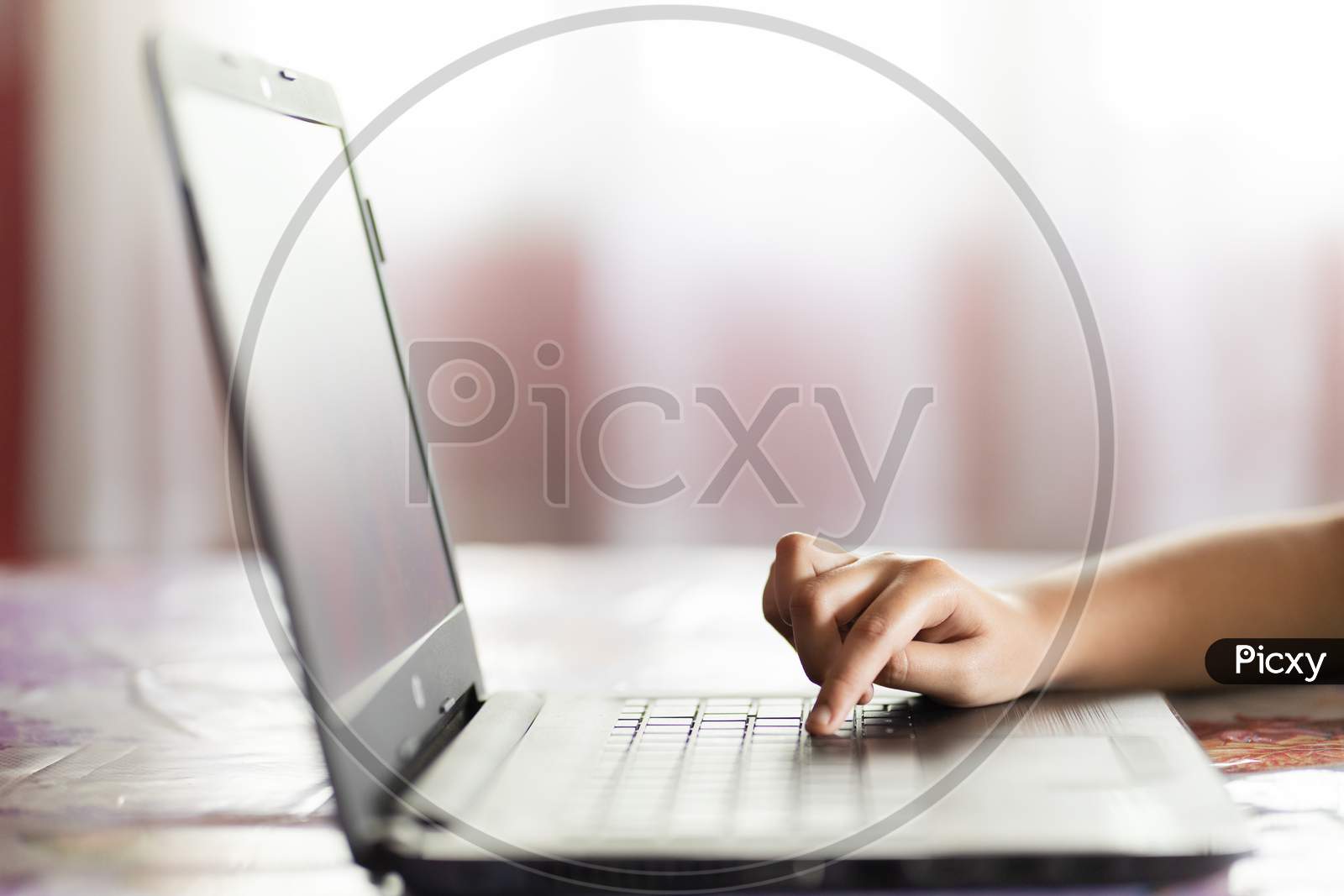 Child Hand Browsing On Laptop Indoors Online Activity