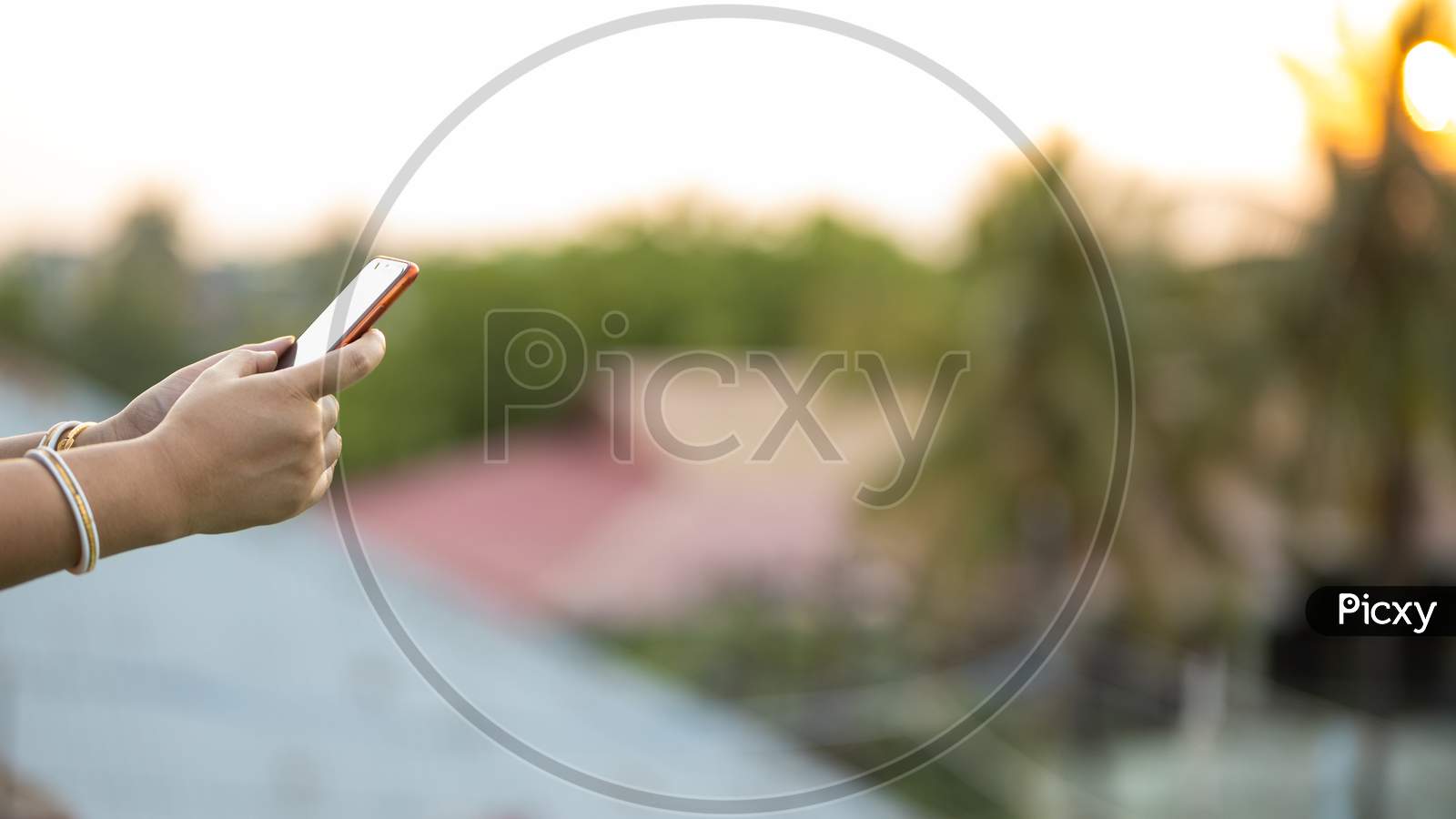 Woman Hand Browsing On Mobile Phone Outdoors
