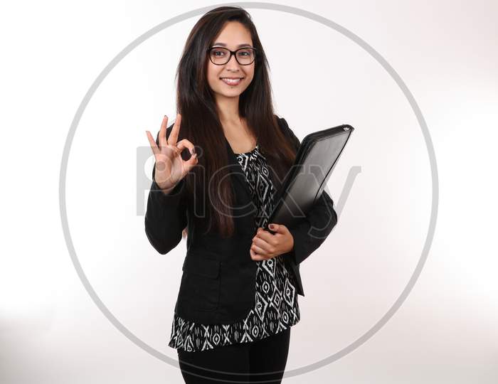 A Young Business Woman Holds Up The Okay Sign.