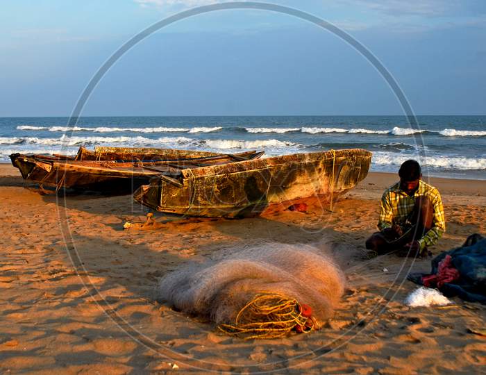 Fishermen working with a fishing net on the sea beach of Puri