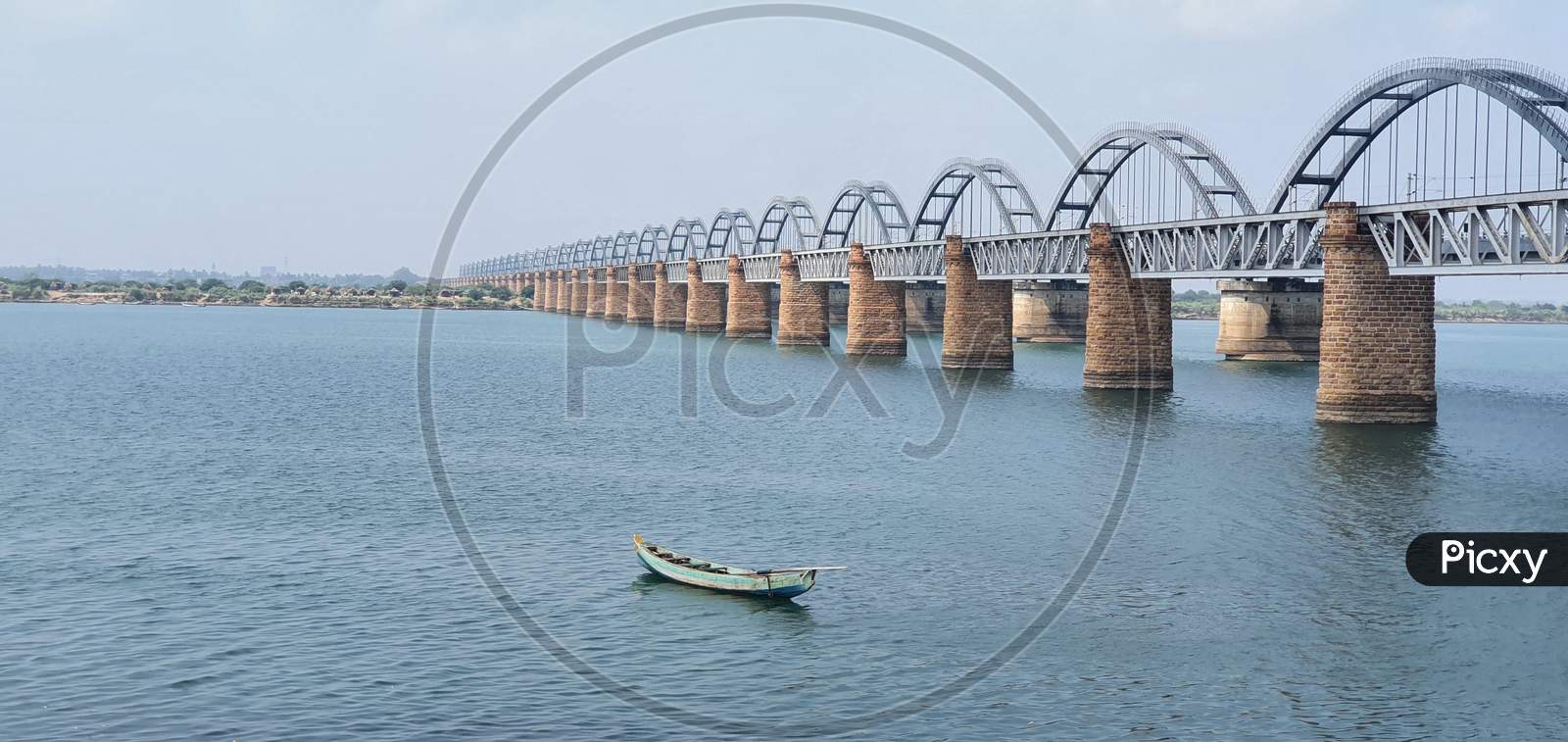 Scenic view of boat anchored close to the bridges on Godavari river