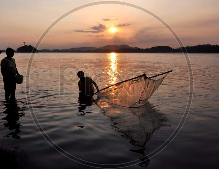 Man Catches Fish At The Banks Of The Brahmaputra River During Sunset  In Guwahati, Saturday, May 9, 2020.