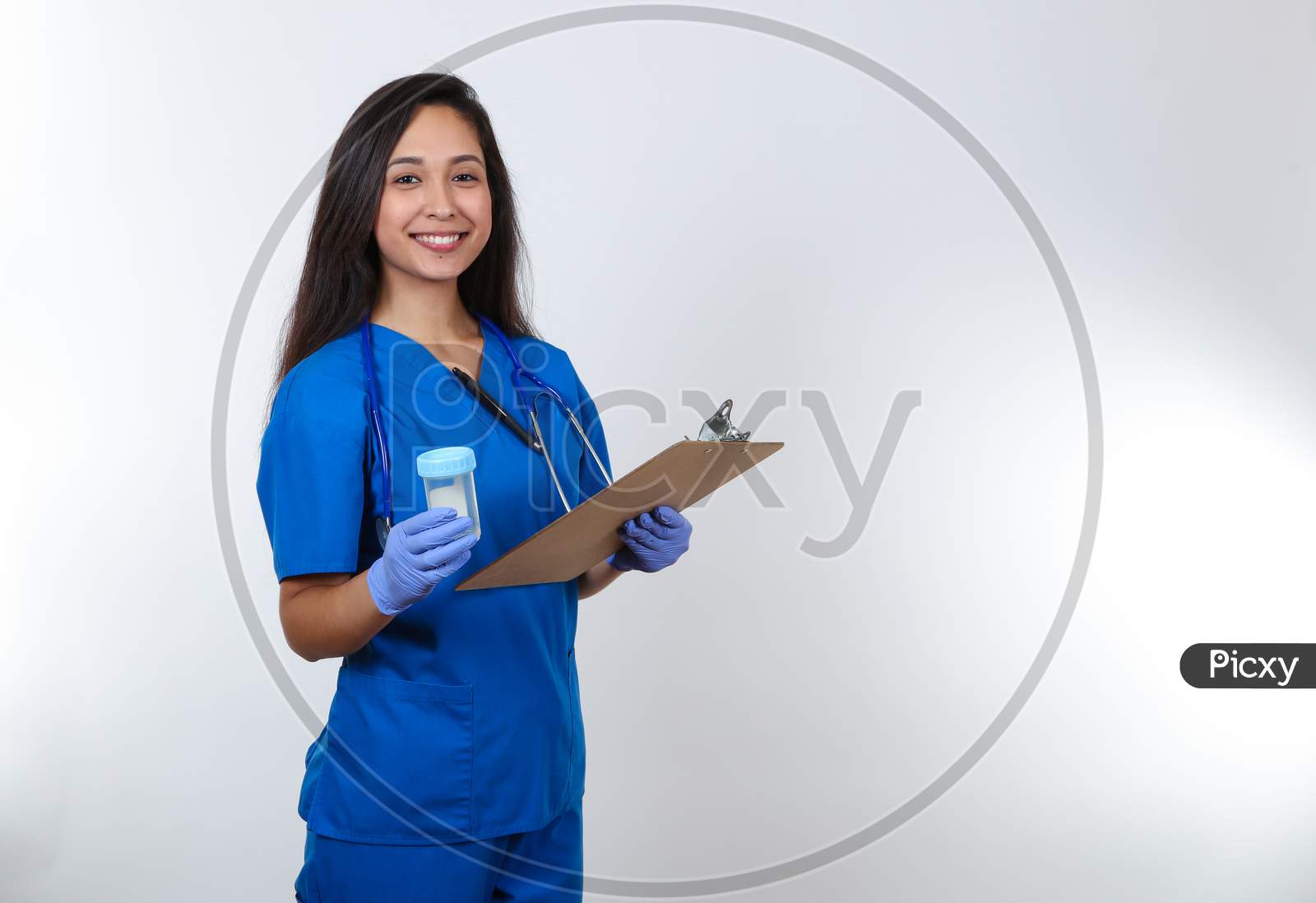 A Cheerful Nurse Holding An Empty Urine Sample Collector Cup For A Drug Test.