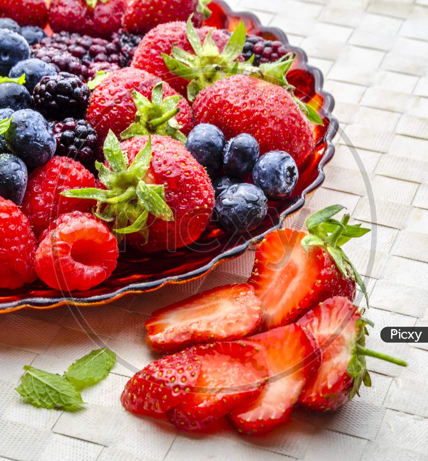 A plate of fresh summer fruit with strawberries