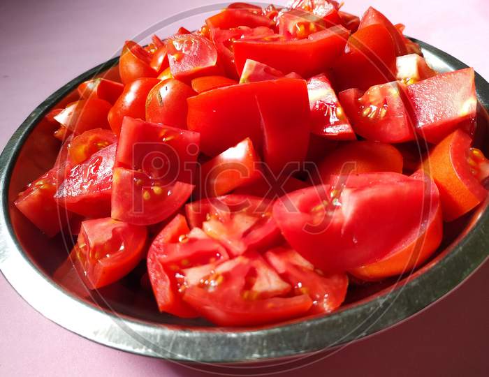 Pieces of tomatoes , ready to cook.
