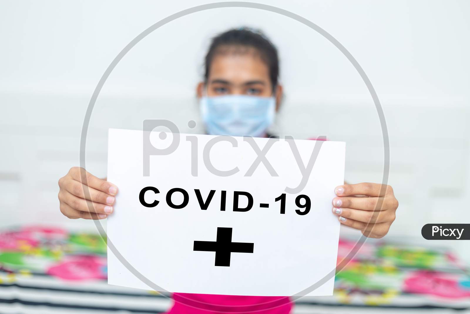 Young Girl Wearing Surgical Protection Mask Holding White Board With Text Covid-19 During Quarantine. Stay At Home Concept.