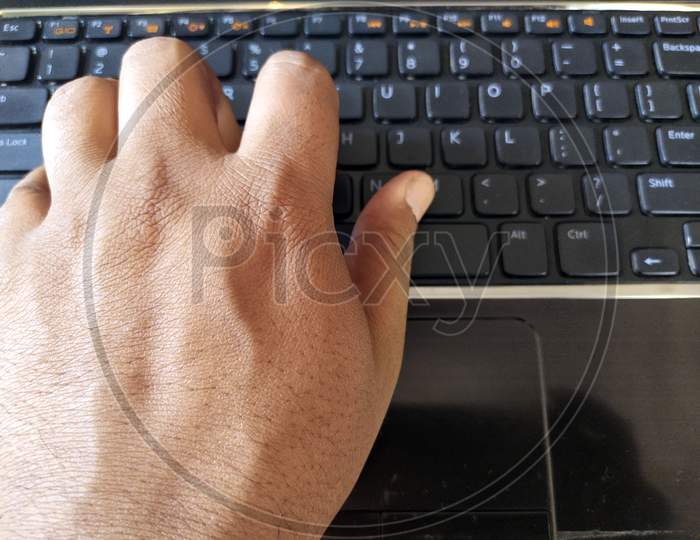 a hand is  business working  typing on laptop keyboard