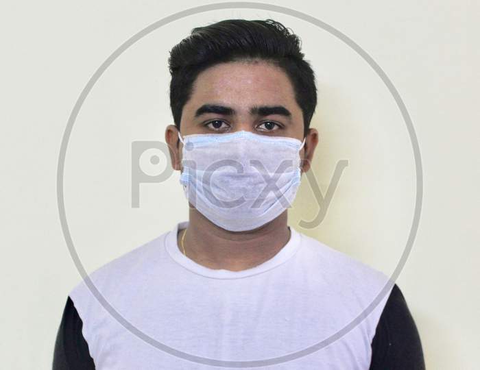 Man in surgical mask pointing himself, wearing protective filter to prevent coronavirus infection, airborne respiratory illness such as COVID19.