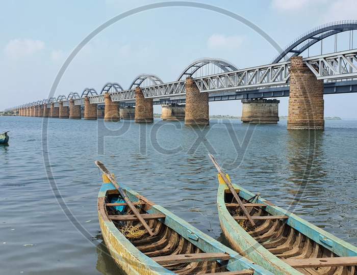 Boats against the backdrop of railway bridges across the Godavari river
