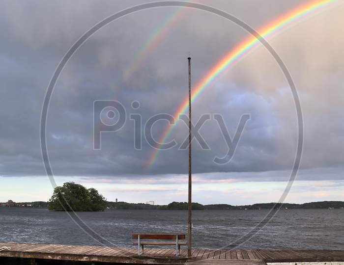Stunning natural double rainbows plus supernumerary bows seen at a lake
