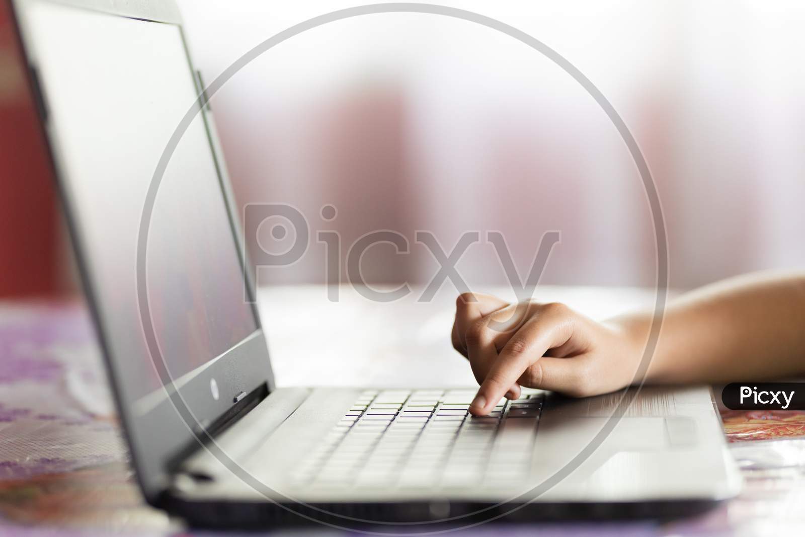Child Hand Browsing On Laptop Indoors Online Activity