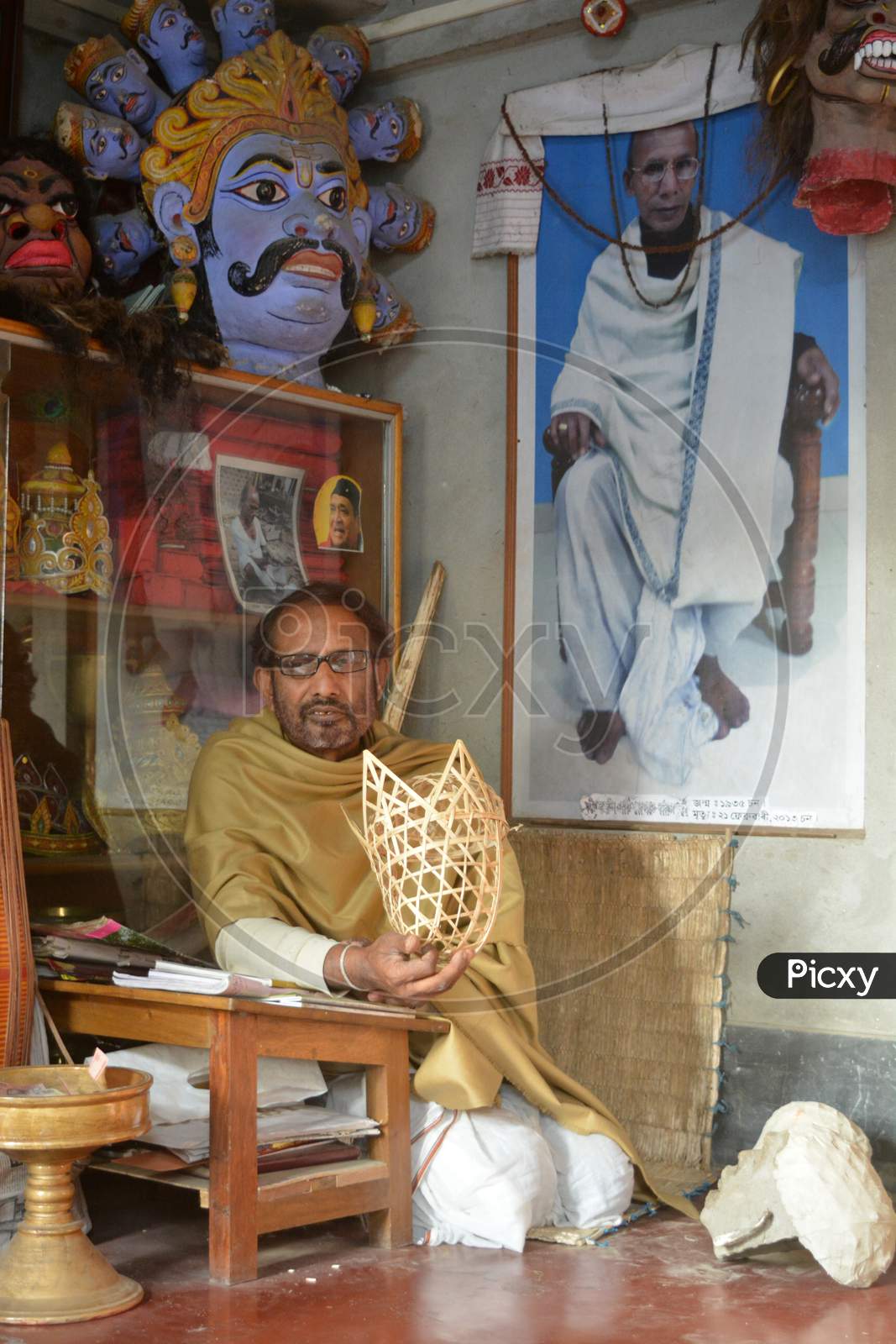 Majuli, Assam/India- January 9 2017: Hemchandra Goswami, who is widely acclaimed for his extraordinary skills of mask making, absorbed in his creation.