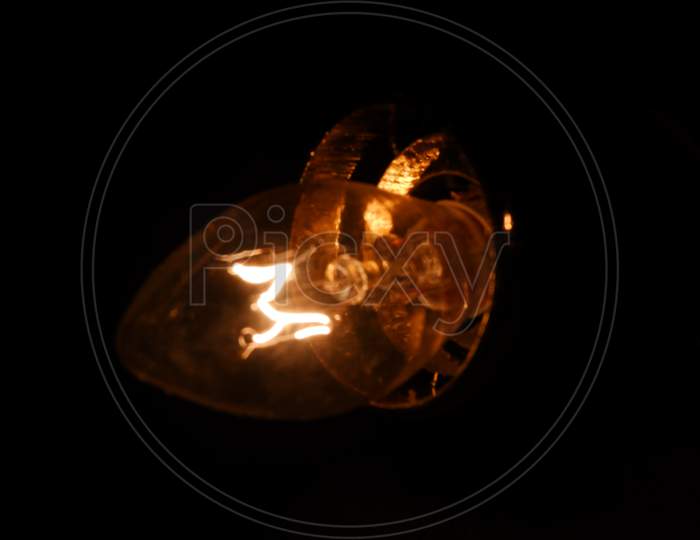 luminous filament lamp in black background
