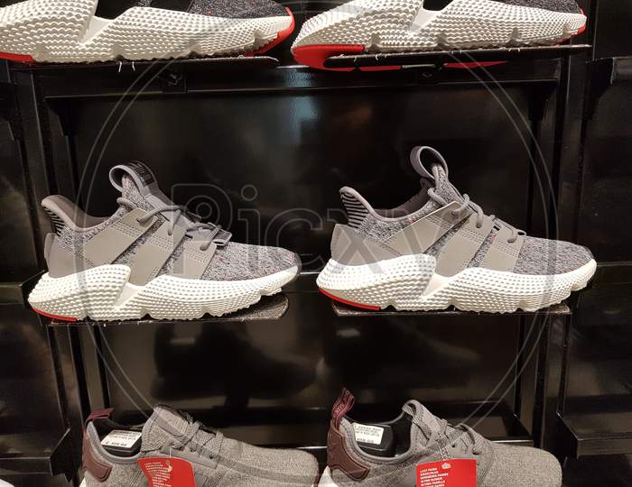 Sports Shoes in a Display Rack in a Store