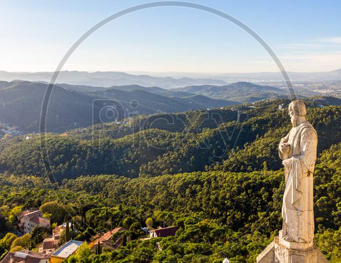 Sculpture Apostle And Mountains Near Barcelona
