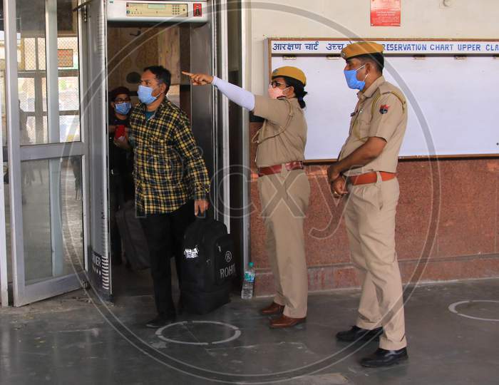 Security personnel direct migrants towards a special train which will be on-boarded by migrants to Bihar State from Ajmer railway station during a government-imposed nationwide lockdown as a preventive measure against the COVID-19 or coronavirus, in Ajmer on May 10, 2020.