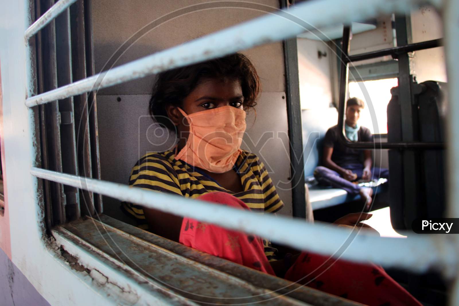 Stranded migrant looks out of a compartment's window during special train going to Bihar State from Ajmer railway station during a government-imposed nationwide lockdown as a preventive measure against the COVID-19 or coronavirus, in Ajmer on May 10, 2020.