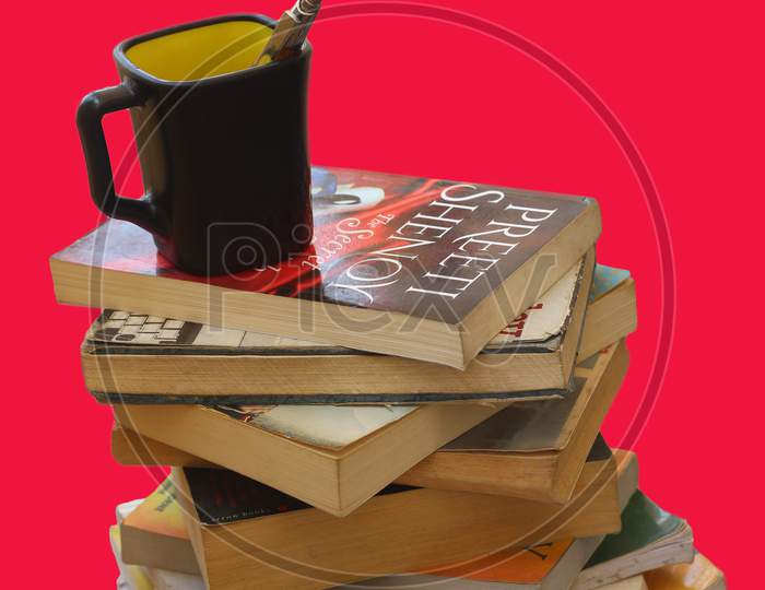 May 2020, Bangalore, Karnataka. Stacks of books and black coffee cup