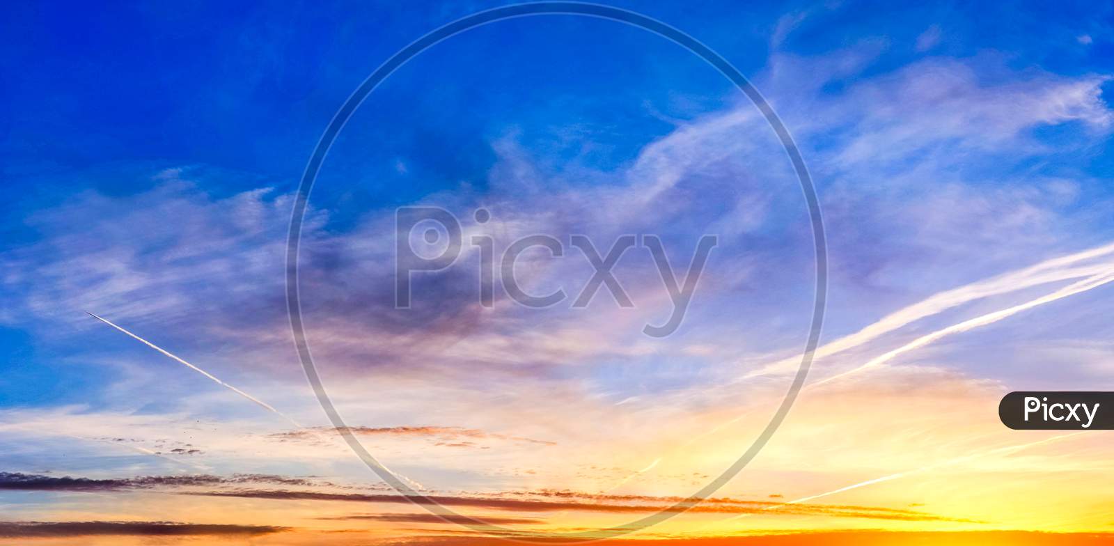 Beautiful red and orange cloud formations at sunrise in  a panorama sky view