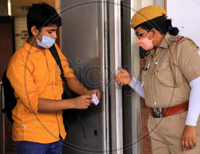 A security personnel checks a migrant near a special train which will be on-boarded by migrants to Bihar State from Ajmer railway station during a government-imposed nationwide lockdown as a preventive measure against the COVID-19 or coronavirus, in Ajmer on May 10, 2020.
