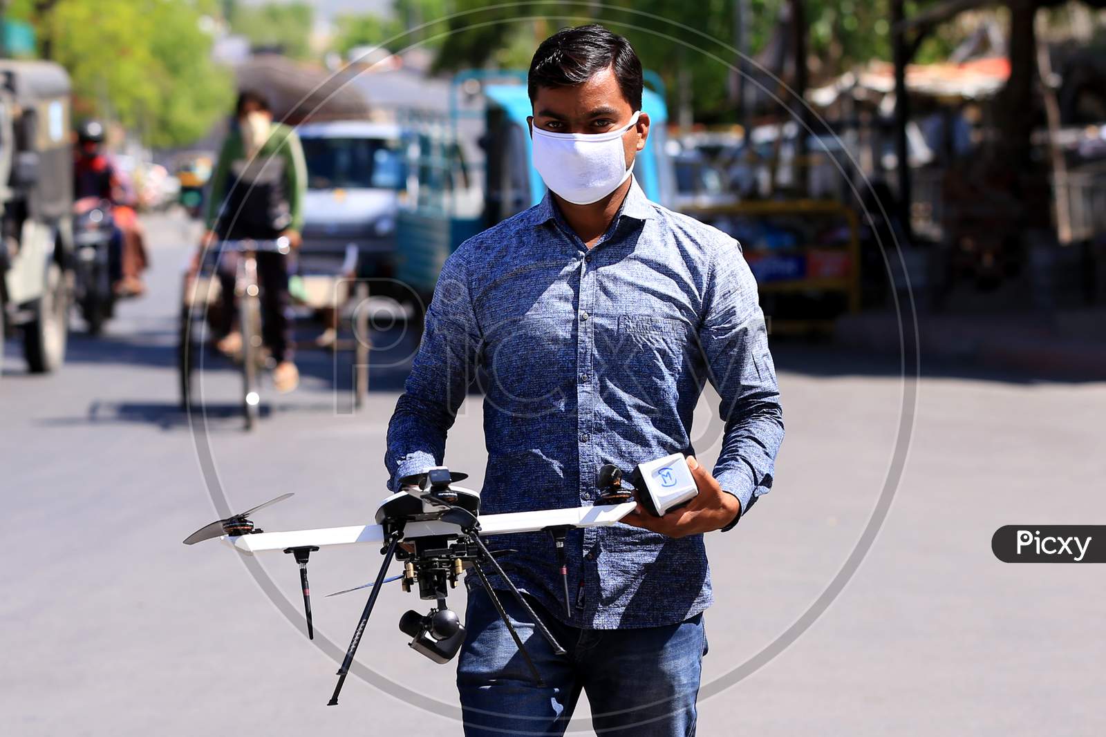 A man holds a drone operated by a security personnel for surveilling a hotspot area during a government-imposed nationwide lockdown as a preventive measure against the COVID-19 or coronavirus, in Ajmer, Rajasthan, India on 06 May 2020.