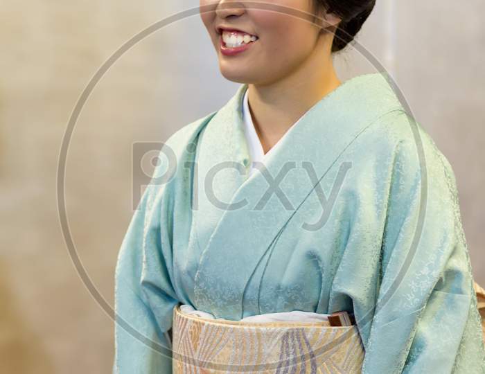 Beautiful Japanese Maiko Geisha Apprentice Girl Dressed In Traditional Kimono In Kyoto, Japan