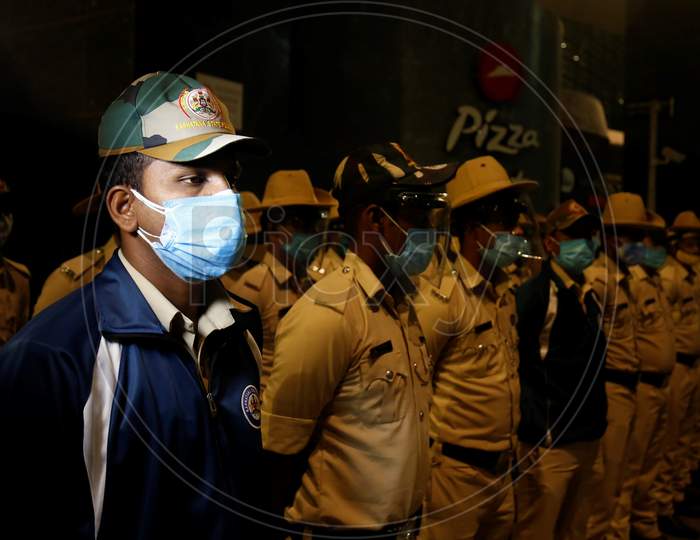 Police personnel stand guard at the Kempegowda International Airport in Bangalore, India, May 11, 2020. Three hundred twenty six passengers stranded in the UK due to the covid-19 lockdown arrived in an Air India flight at the break of dawn.