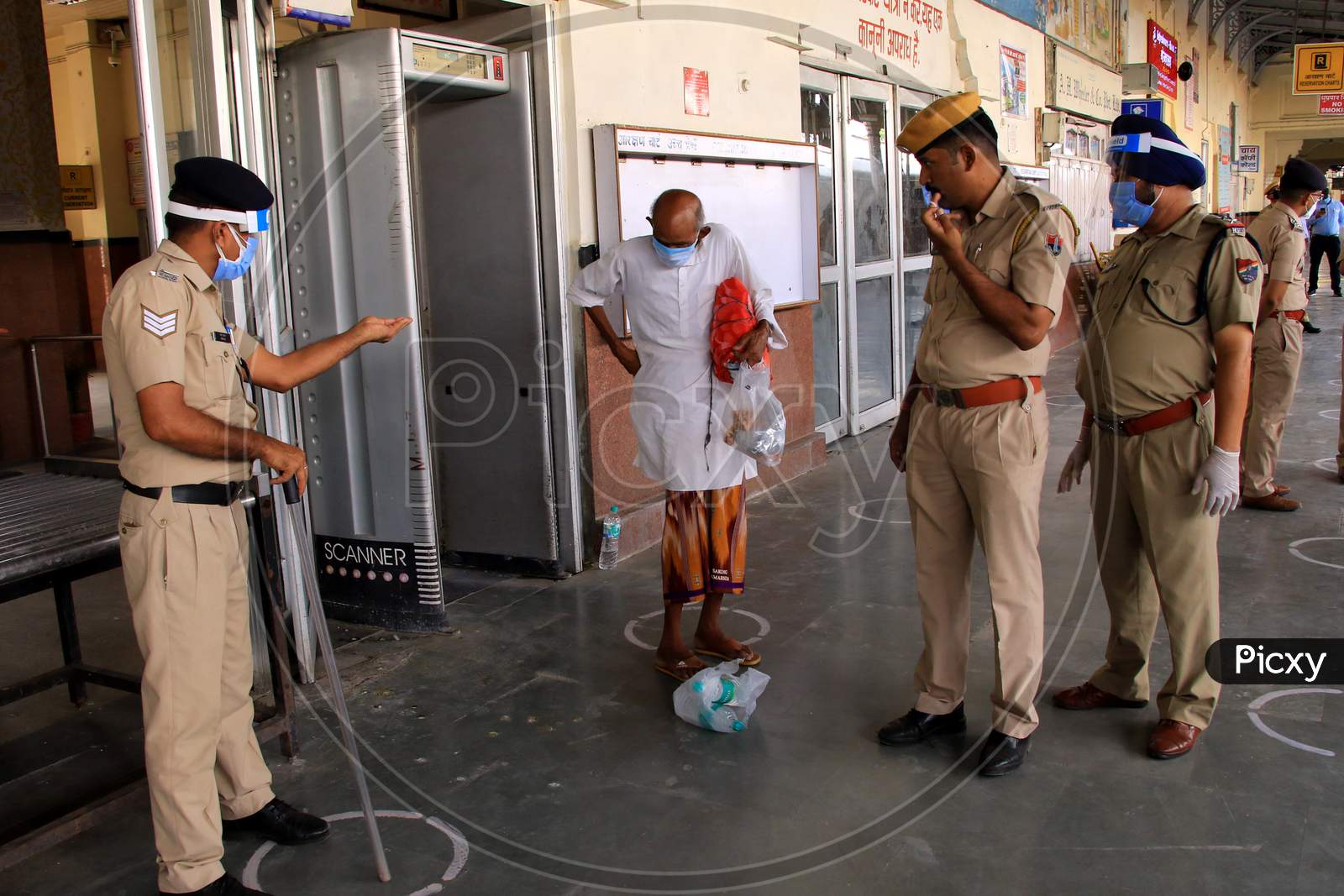 Security Personnel Check Migrants Near A Special Train Which Will Be On-Boarded By Migrants To Bihar State From Ajmer Railway Station During A Government-Imposed Nationwide Lockdown As A Preventive Measure Against The Covid-19 Or Coronavirus, In Ajmer On May 10, 2020.