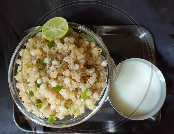 Sabudana khichadi dish. Sabudana khichadi and lemon. Sago receipe in a bowl. Served traditional receipe sabudana khichadi