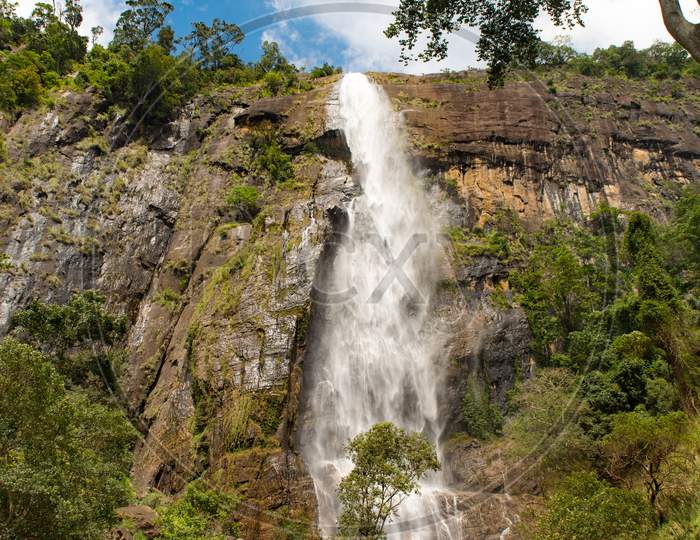 Sunny Day In The Tropical Waterfall Falls From The Mountain Cliff To The Jungle, Serene Landscape Of Diyaluma Falls.