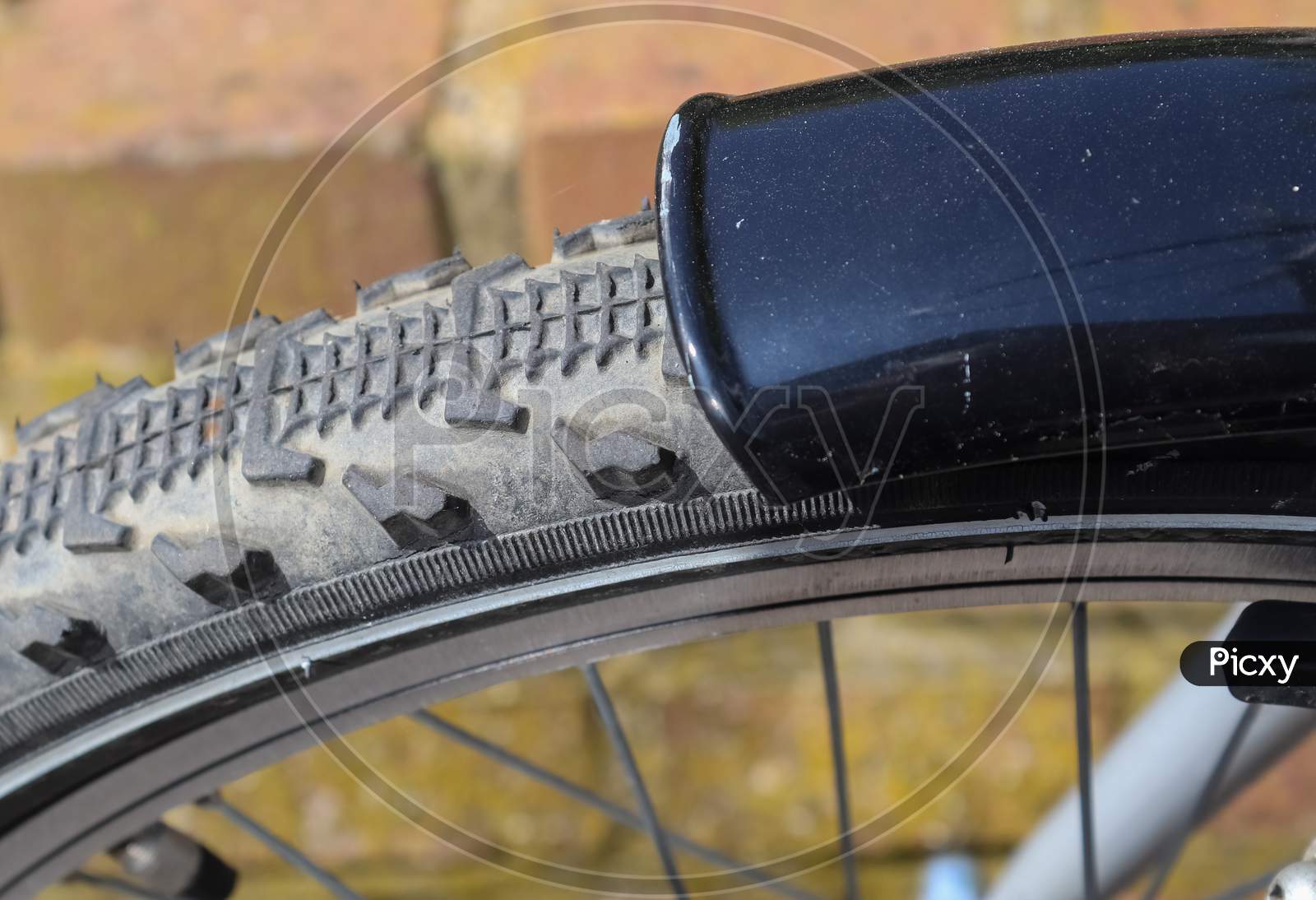 Close up view at a bicycle wheel with metal spokes