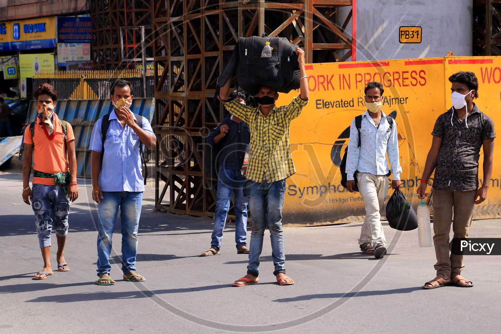 Stranded migrants wait to board a special train to Bihar State from Ajmer railway station during a government-imposed nationwide lockdown as a preventive measure against the COVID-19 or coronavirus, in Ajmer on May 10, 2020.