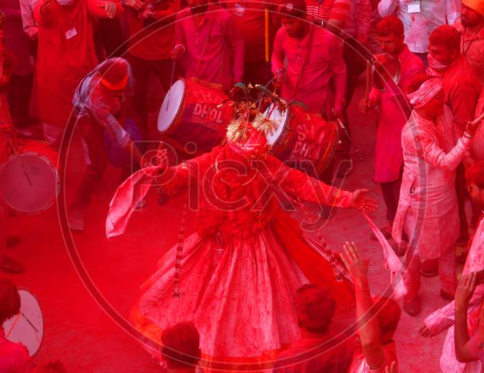 A man daubed in colour dances as he takes part in a colourful procession locally known as "Badshah ki Sawari" as part of Holi, the Festival of Colours, celebrations in Beawar, in the desert state of Rajasthan, India, 11 March 2020.
