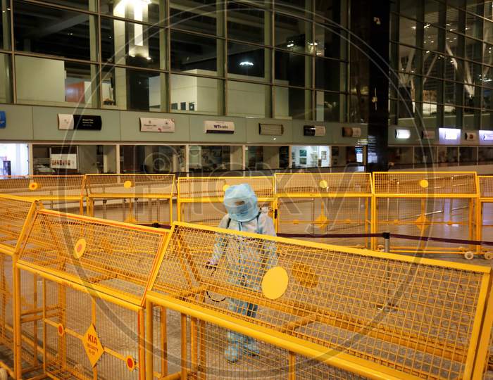 An airport worker sprays disinfectant at the Kempegowda International Airport in Bangalore, India, May 11, 2020. Three hundred twenty six passengers stranded in the UK due to the covid-19 lockdown arrived in an Air India flight at the break of dawn.