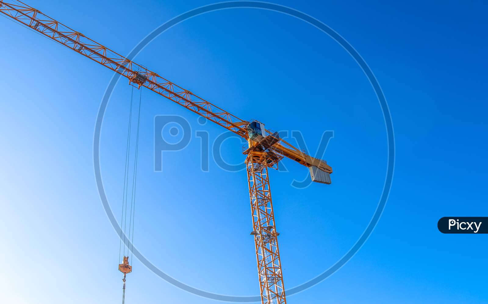 Big yellow cranes at a construction site on a sunny day