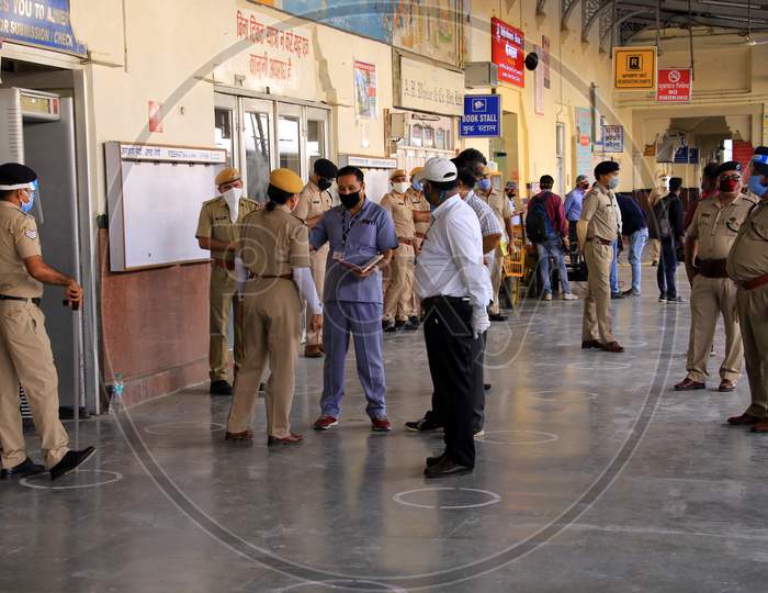  Security personnel stand near a special train which will be on-boarded by migrants to Bihar State from Ajmer railway station during a government-imposed nationwide lockdown as a preventive measure against the COVID-19 or coronavirus, in Ajmer on May 10, 2020.
