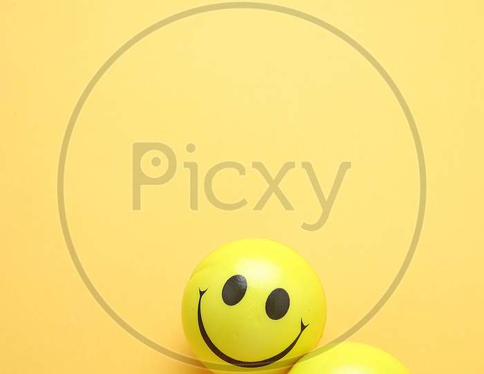 Smile Yellow Balloon.Toy Ball On Yellowbackground. Smile Icons. Emoji. Emoticons .Top View Flat Lay Copy Space