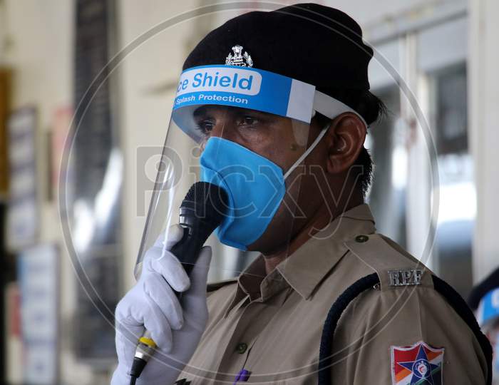 A security personnel stands near a special train which will be on-boarded by migrants to Bihar State from Ajmer railway station during a government-imposed nationwide lockdown as a preventive measure against the COVID-19 or coronavirus, in Ajmer on May 10, 2020.