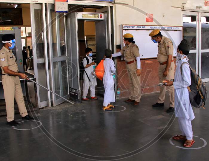  Security personnel direct migrants towards a special train which will be on-boarded by migrants to Bihar State from Ajmer railway station during a government-imposed nationwide lockdown as a preventive measure against the COVID-19 or coronavirus, in Ajmer on May 10, 2020.