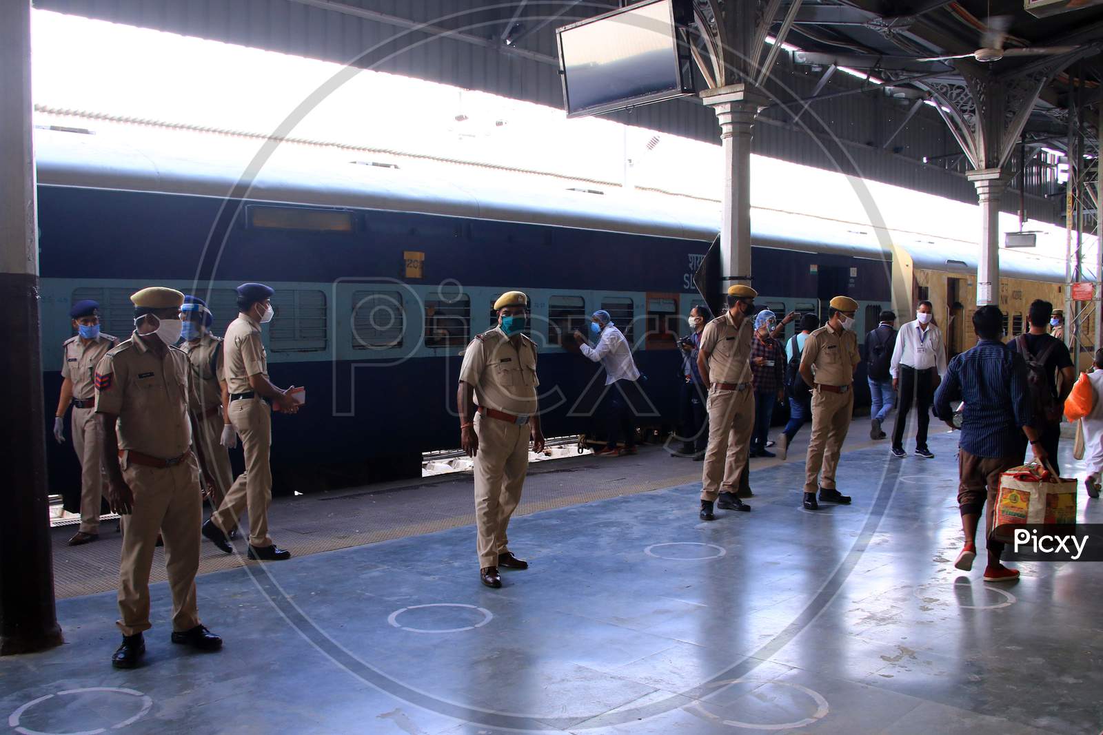Security personnel stand near a special train which will be on-boarded by migrants to Bihar State from Ajmer railway station during a government-imposed nationwide lockdown as a preventive measure against the COVID-19 or coronavirus, in Ajmer on May 10, 2020.