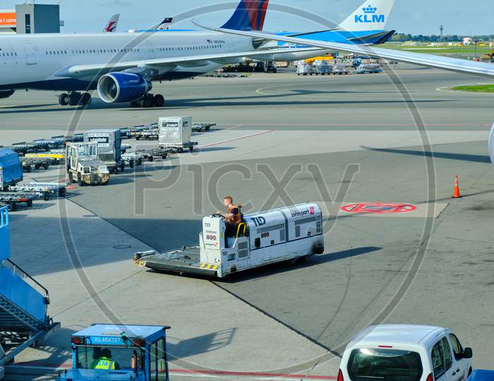 Airport Baggage Tractor At Amsterdam Airport Schiphol In Amsterdam, Netherlands
