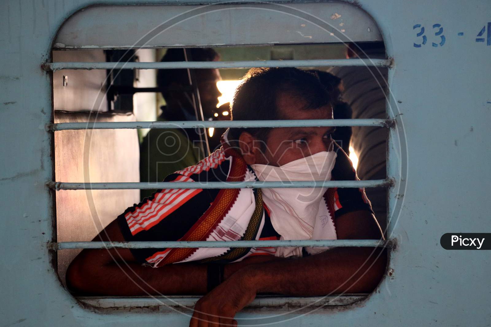 Stranded migrant looks out of a compartment's window during special train going to Bihar State from Ajmer railway station during a government-imposed nationwide lockdown as a preventive measure against the COVID-19 or coronavirus, in Ajmer on May 10, 2020.